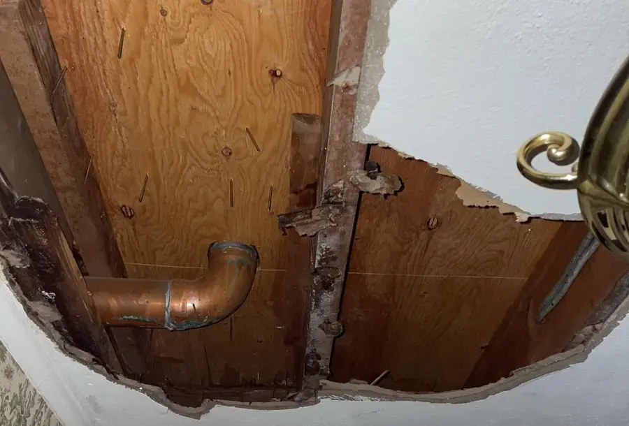 Ceiling opened to reach a leaking copper drain line in Lodi